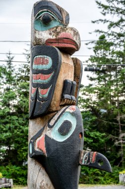 Saxman, Alaska - July 29, 2022: Tlinget totem poles, long house and traditional art.
