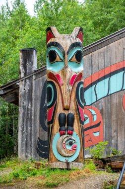 Saxman, Alaska - July 29, 2022: Tlinget totem poles, long house and traditional art.