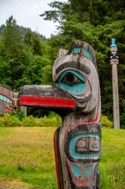 Saxman, Alaska - July 29, 2022: Tlinget totem poles, long house and traditional art.