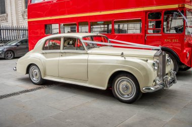 London, UK - August 21, 2022: Rolls-Royce classic car decorated for a wedding outside St Pauls Cathedral in London.