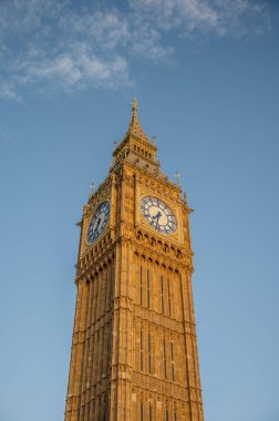 Big Ben, London, UK. A view of the popular London landmark, the clock tower known as Big Ben in evening light against a blue sky.