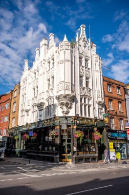 London, UK - August 23, 2022: Street front of Rising Sun, a traditional Victorian pub established in 1730 and located on Tottenham Court Road, London.