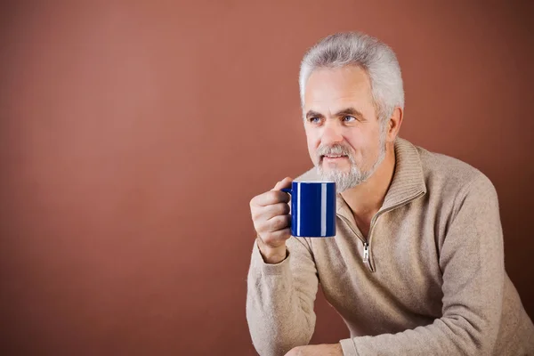 Smiling senior with a cup — Stock Photo, Image