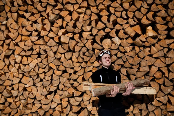 Smiling man with firewood