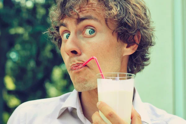 Portrait of funy curl man drinking through straw Royalty Free Stock Images