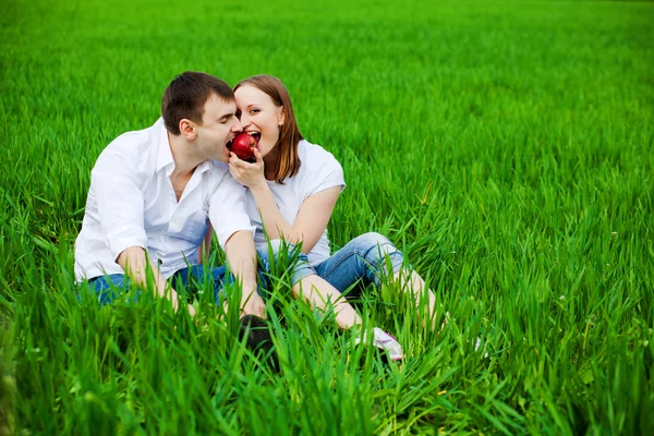 Lovers eating red apple — Stock Photo, Image