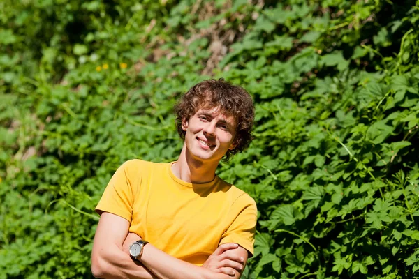 Een krullend jongeman in een forest — Stockfoto