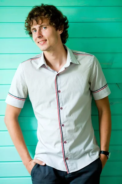 Young man on green background — Stock Photo, Image