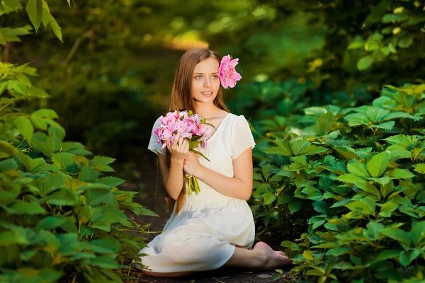 Menina bonita com buquê de flores ao ar livre — Fotografia de Stock