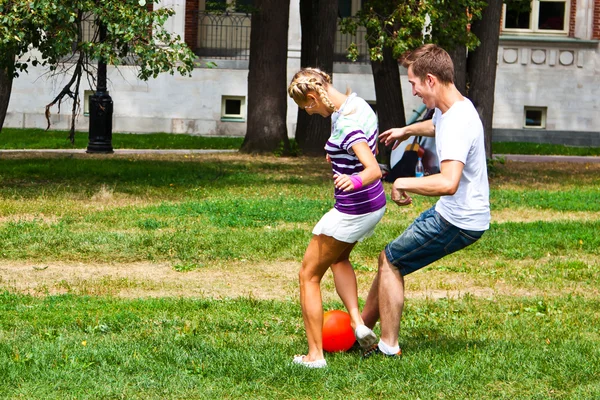 Man and woman playing football — Stock Photo, Image