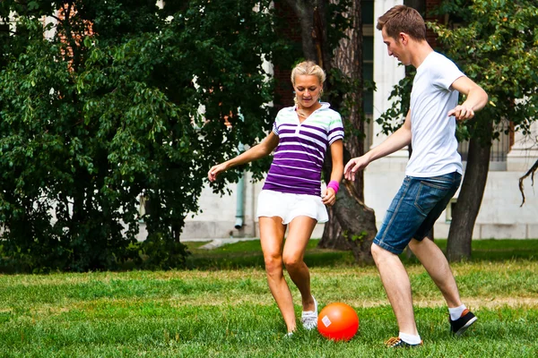 Man and woman playing football — Stock Photo, Image