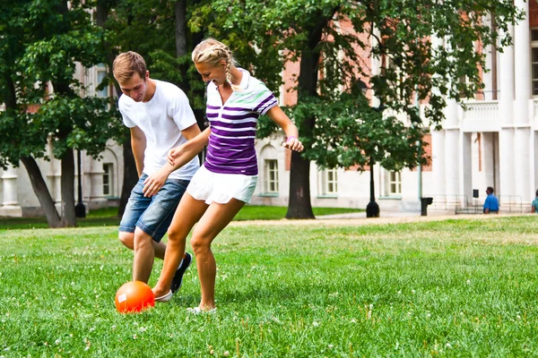 Man and woman playing football — Stock Photo, Image