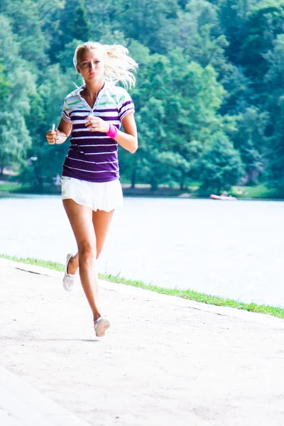 Woman running in the park Royalty Free Stock Photos