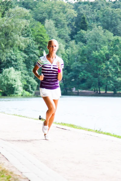 Woman running in the park Stock Image