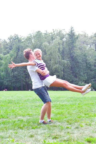 Man holding woman on his back — Stock Photo, Image