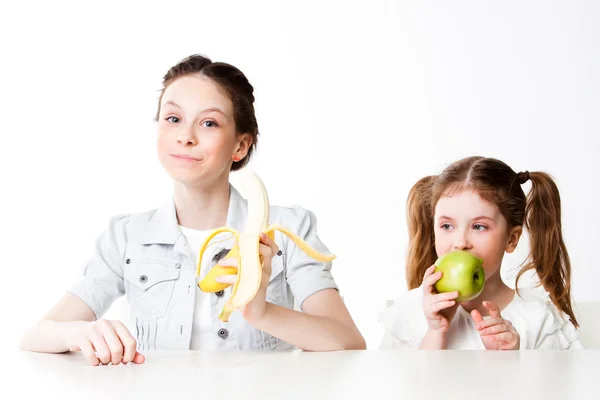 Girl with a banana and an apple — Stock Photo, Image