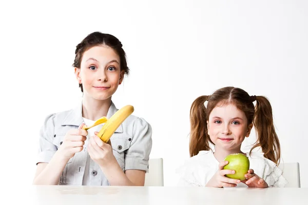 Girl with a banana and an apple — Stock Photo, Image
