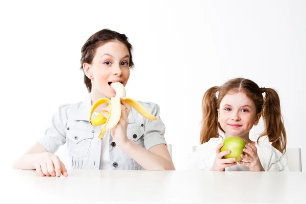 Girl with a banana and an apple — Stock Photo, Image