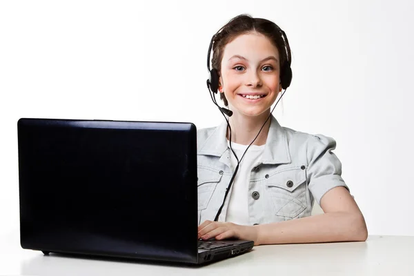 Girl with a laptop and headset — Stock Photo, Image