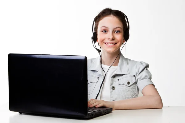 Girl with a laptop and headset — Stock Photo, Image