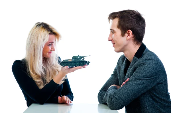 Woman gives a man a toy tank — Stock Photo, Image