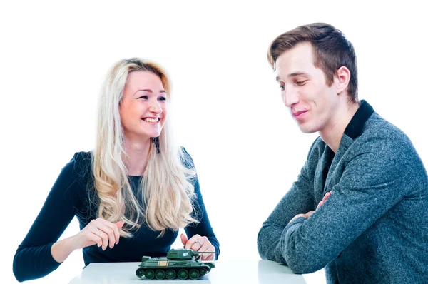 Woman gives a man a toy tank — Stock Photo, Image