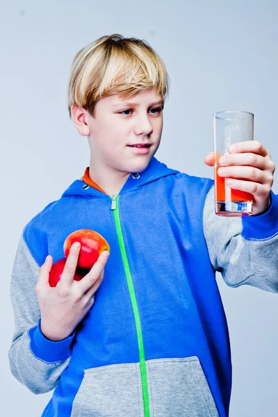 Boy with an apple and juice — Stock Photo, Image