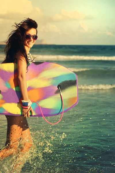 Menina feliz correndo rindo alegre se divertindo com bodyboardin Imagens De Bancos De Imagens