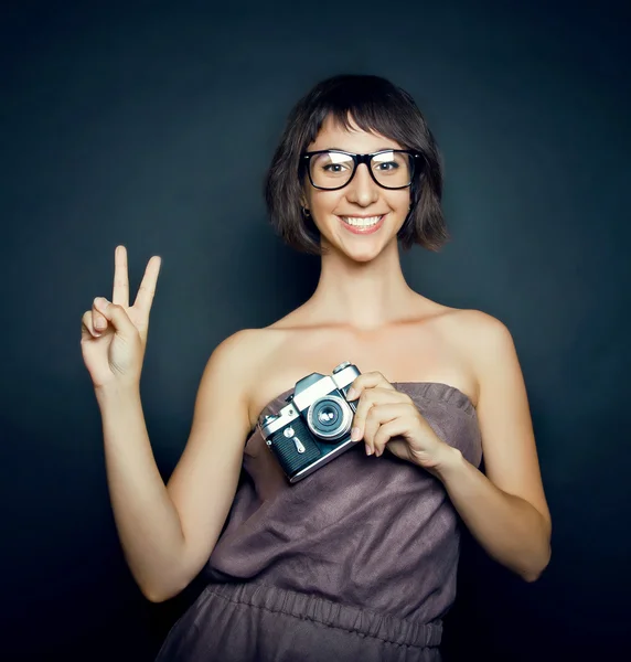 Positive smiling girl with camera — Stock Photo, Image