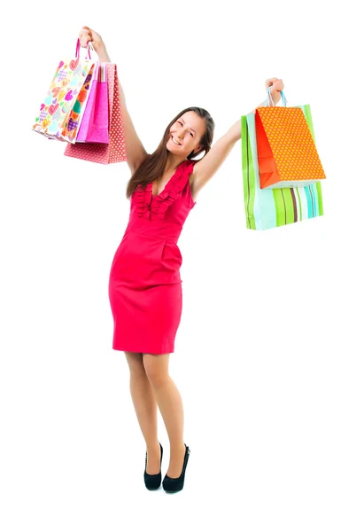 Young happy girl with shopping bags in hands isolated — Stock Photo, Image