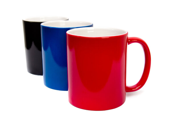 color ceramic cups on a white background