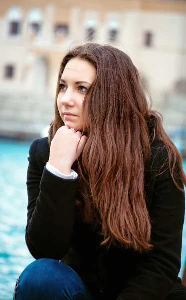 Pensive young girl on the waterfront — Stock Photo, Image