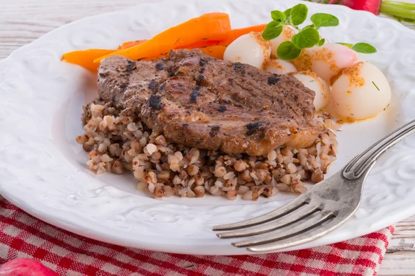 Grill chop, buckwheat groats and roasted radishes — Stok fotoğraf