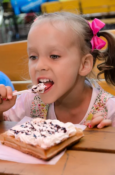 Small girls in waffle food — Stock Photo, Image