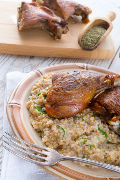 Roasted goose thighs with grits — Stock Photo, Image