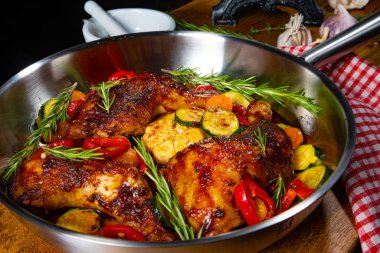 Çeşitli sebze ve baharatlarla kızarmış tavuk bacağı.