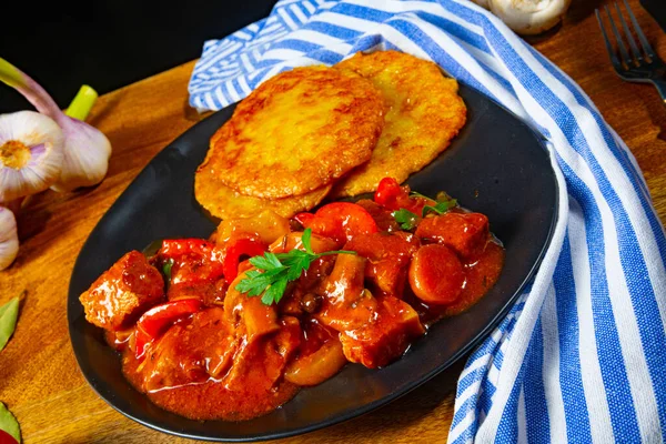 Original Hungarian goulash with potato pancakes