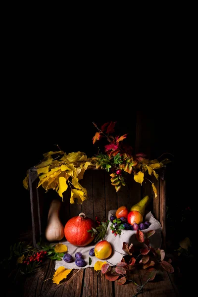 秋の紅葉のある木箱の中に様々な果物 — ストック写真