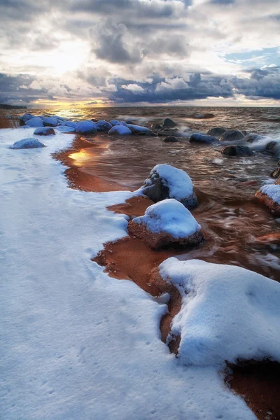 Sandy beach with rocks at the sea — Stock Photo, Image