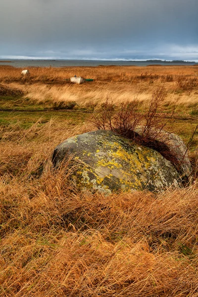 Old stone split and boat on the beach — Stock Photo, Image