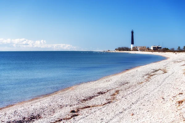siyah fener mavi denizi ve beyaz taşlar
