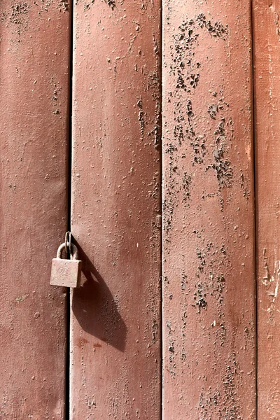 Old wooden shutters on the lock — Stock Photo, Image