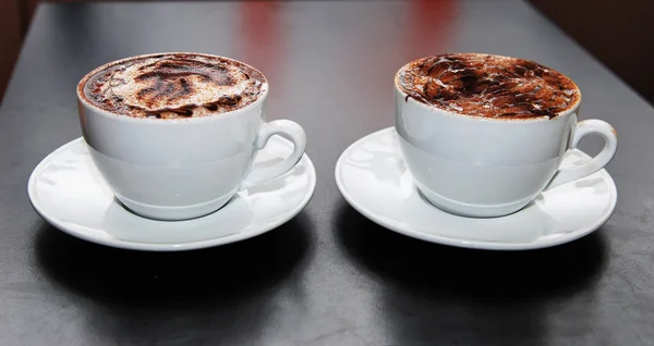 Two cappuccino coffe cup at the table — Stock Photo, Image