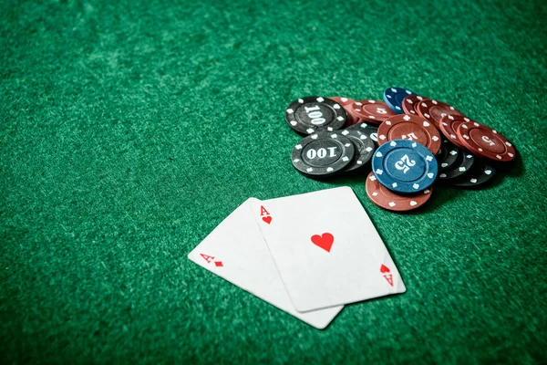 Aces and chips on a green felt — Stock Photo, Image