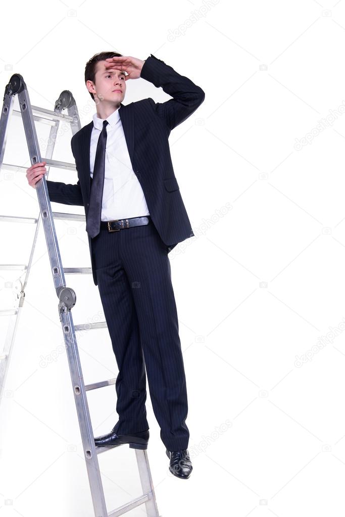 Young businessman on a ladder searching for possibilities