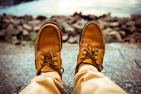 Close-up view of man's leather top sider shoes
