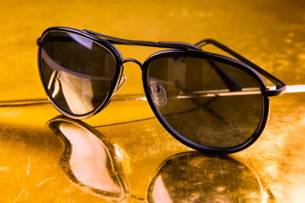 Luxury aviator sunglasses on golden background — Stock Photo, Image