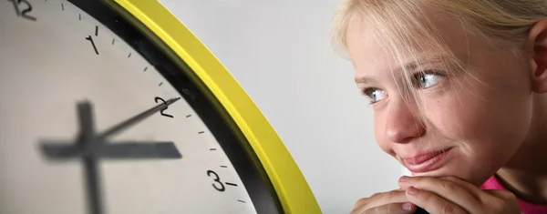 Girl and yellow clock — Stock Photo, Image