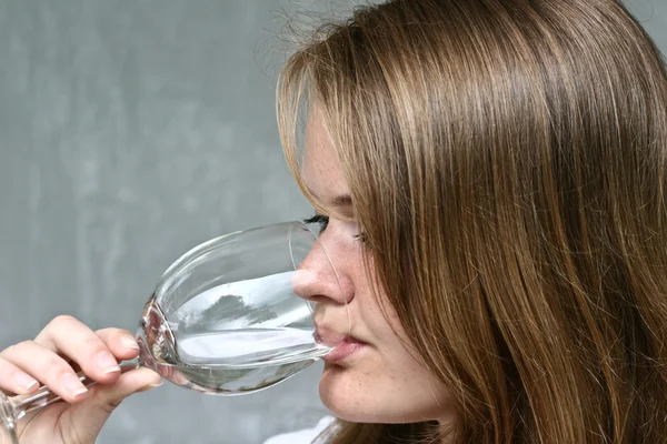 Girl drinking water in glass — Stock Photo, Image