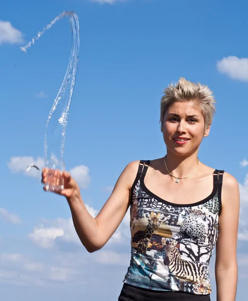 Cute blond girl playing with water — Stock Photo, Image